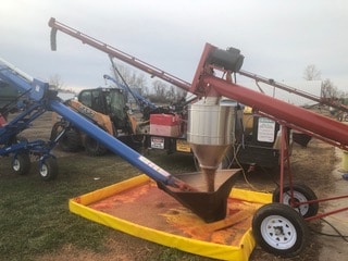 Auger loading treated seed