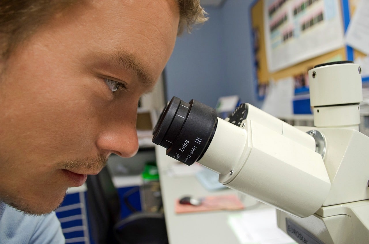 Man looking in microscope