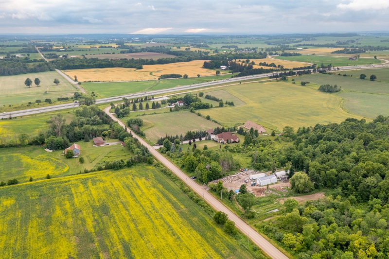 Aerial view of rapeseed field and Highway ON-400, Bradford West Gwillimbury, Canada